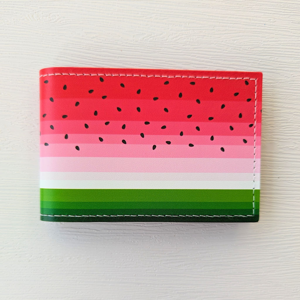 A recycled leather travel card holder featuring a brightly coloured watermelon print, closed, on a white background.