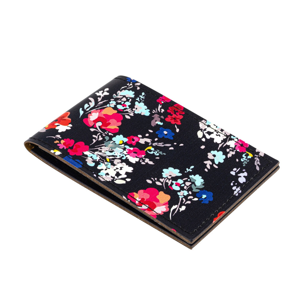 Side view of a recycled leather travel card holder featuring a dark blue floral print pattern, on a white background.