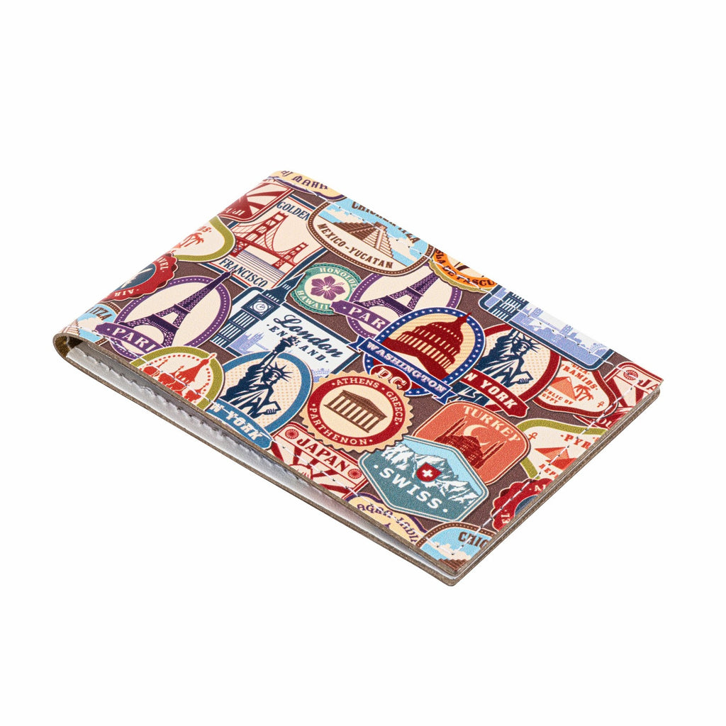 A side view of a recycled leather travel card holder featuring a travel themed print pattern, on a white background.