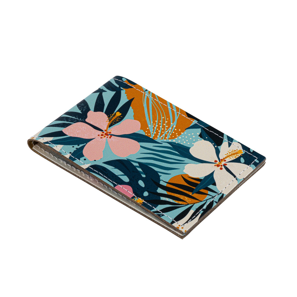 side view of a recycled leather travel card holder featuring a tropical floral print pattern, on a white background.