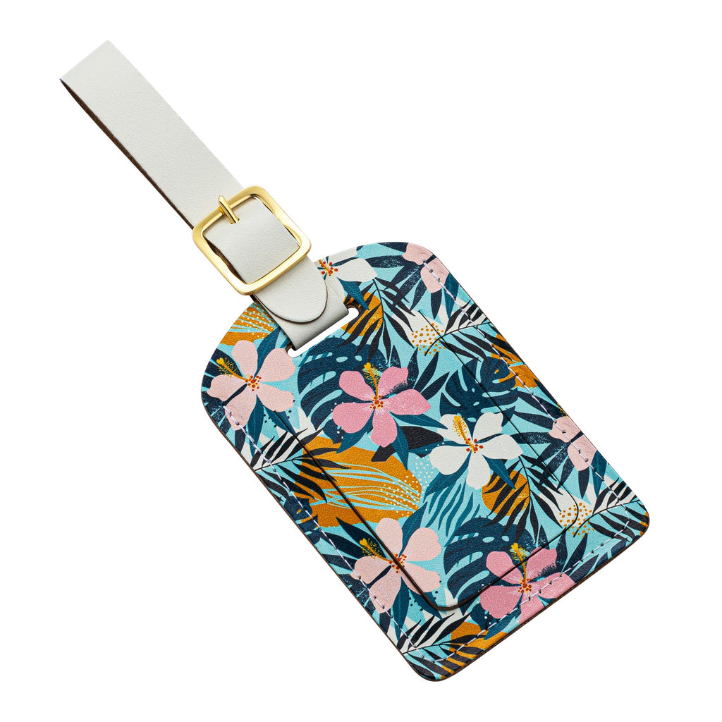 Recycled Leather Luggage Tag featuring a tropical floral-patterned print, with a flap covering the personal details card, with a strap finished with a sleek gold-plated buckle, photographed at an angle, on a white background.