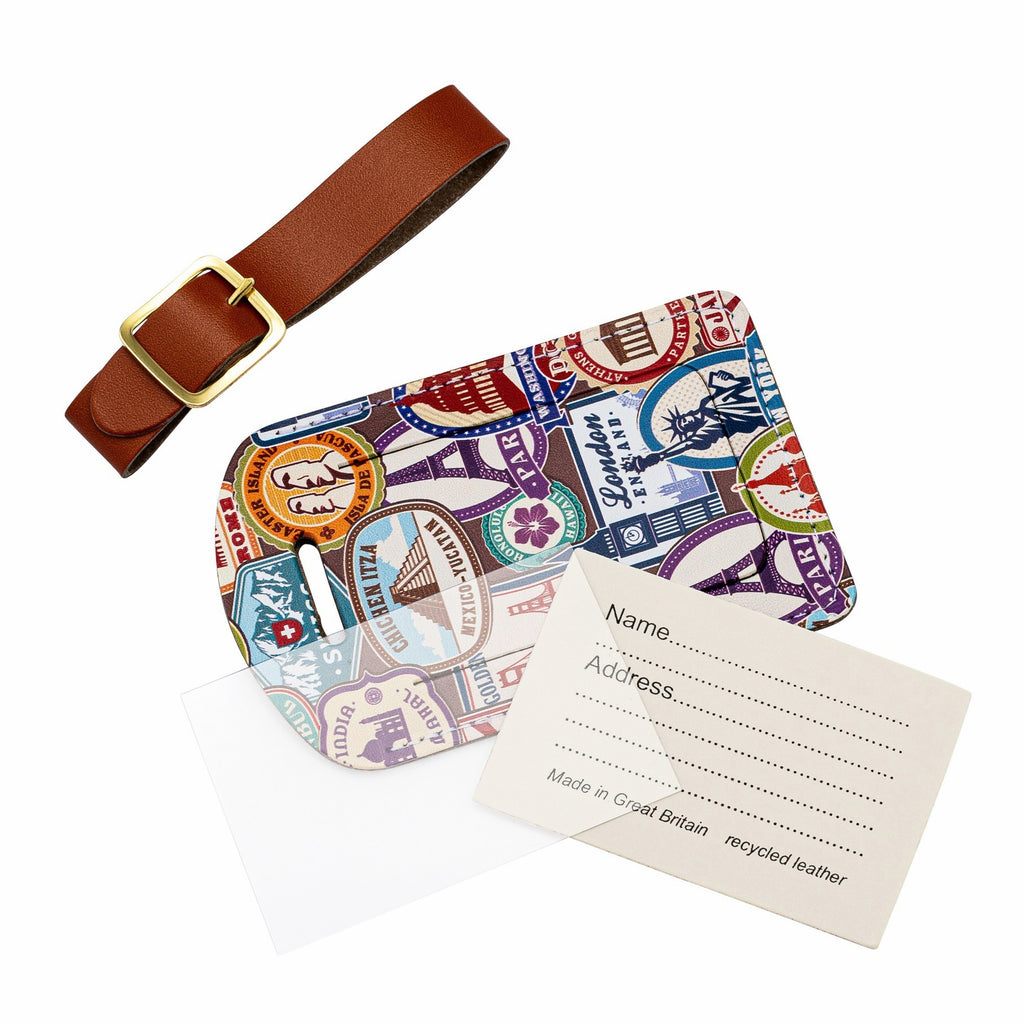 Recycled Leather Luggage Tag featuring travel themed print pattern, in parts, including a tag, a brown strap finished with a sleek gold-plated buckle, an address card and a plastic address card cover, all on a white background.
