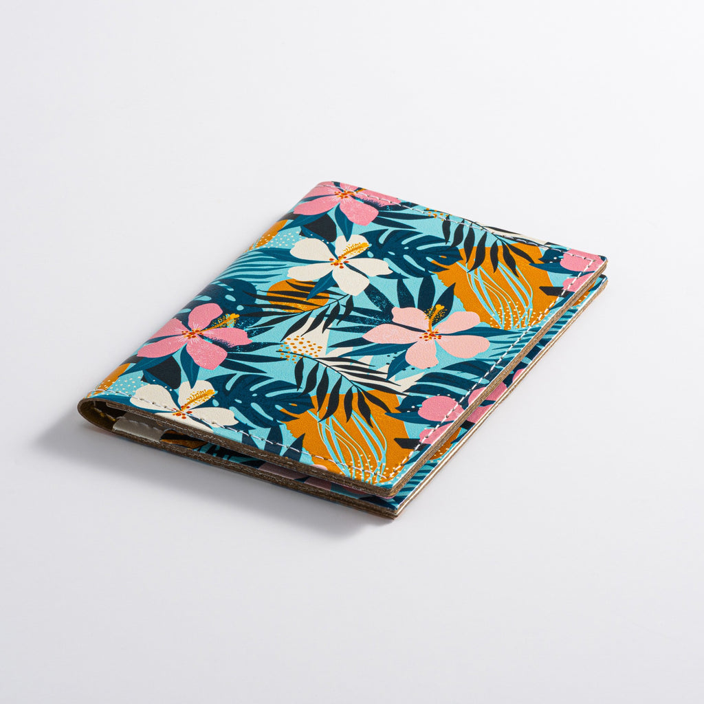 Recycled Leather Folding Wallet Card Holder featuring Tropical Floral Print, lying closed, on a white background.