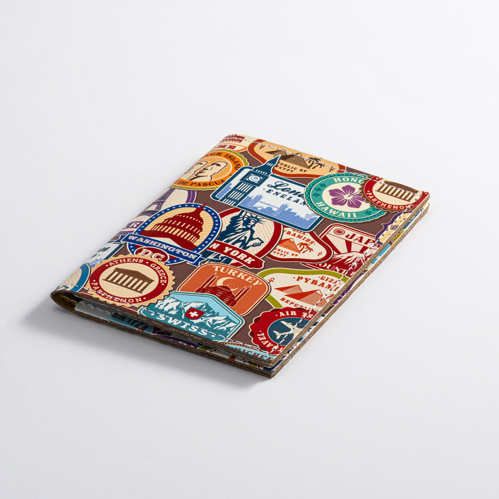 Recycled Leather Folding Wallet Card Holder featuring travel themed print, closed, on a white background.